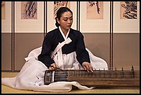 Woman playing traditional instrument. South Korea (color)