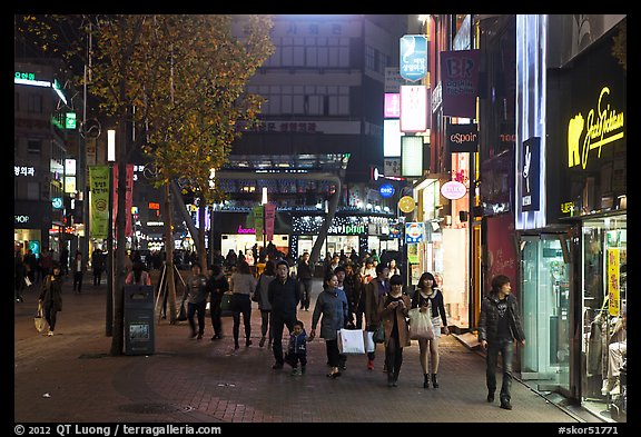 Shoppers strolling on pedestrian street at night. Daegu, South Korea
