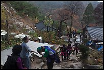 Hikers receiving sacred bread at Sangseonam hermitage, Mt Namsan. Gyeongju, South Korea (color)