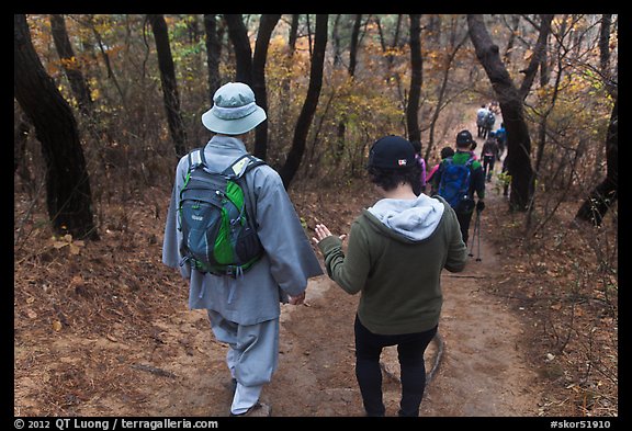 Monk and hikers on trail, Namsan Mountain. Gyeongju, South Korea (color)