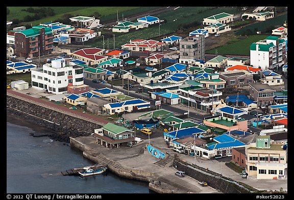 Houses with blue roofs, Seongsang Ilchulbong from above. Jeju Island, South Korea