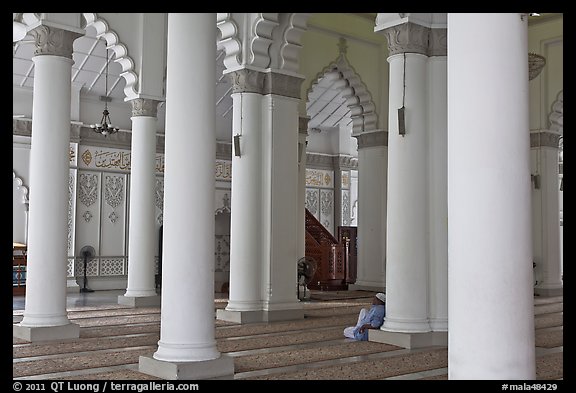 Man in prayer inside Masjid Kapitan Keling mosque. George Town, Penang, Malaysia (color)