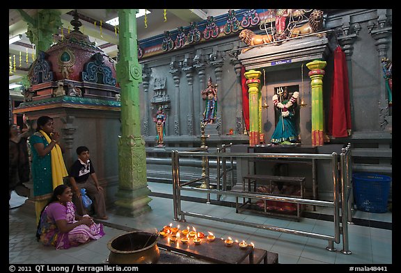 Family in prayer, Sri Mariamman Temple. George Town, Penang, Malaysia (color)