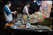Men arranging skewers on hawker stall. George Town, Penang, Malaysia ( color)