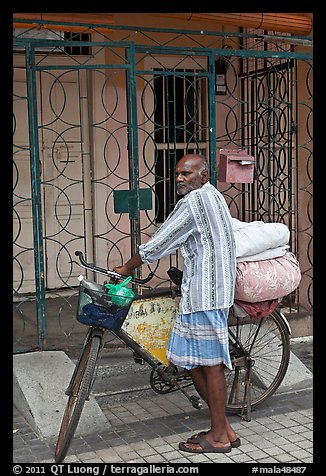 Malay with loaded bicycle. George Town, Penang, Malaysia (color)