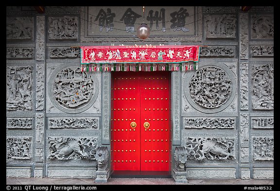 Red door and slate carved wall, Hainan Temple. George Town, Penang, Malaysia