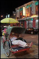 Driver taking nap in trishaw at night. George Town, Penang, Malaysia ( color)