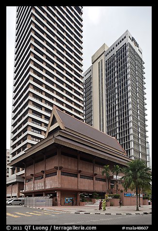 Wooden traditional building at the base of high-rises. Kuala Lumpur, Malaysia (color)