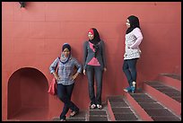 Young women with islamic headscarfs and modern fashions. Malacca City, Malaysia (color)
