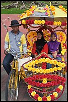 Rider and two women passengers, bicycle rickshaw. Malacca City, Malaysia (color)