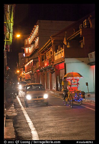 Car and bicycle rickshaw at night. Malacca City, Malaysia (color)