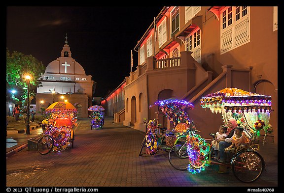 Illuminated trishaws on Town Square at night. Malacca City, Malaysia (color)