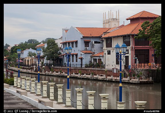 Lamps, riverside houses and St Peters Church towers. Malacca City, Malaysia