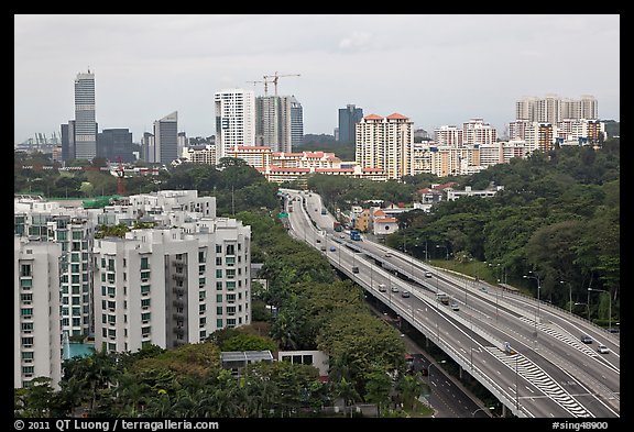 Freeway bordered by parklands and high rises. Singapore