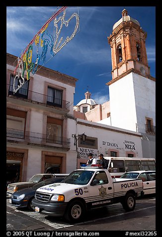 Policemen riding in the back of a pick-up truck. Zacatecas, Mexico (color)