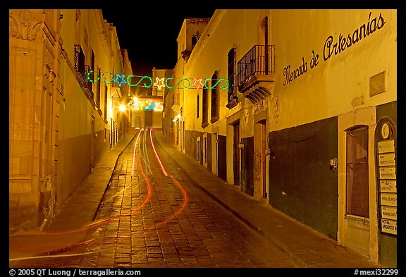 Uphill paved street by night with light trail. Zacatecas, Mexico (color)