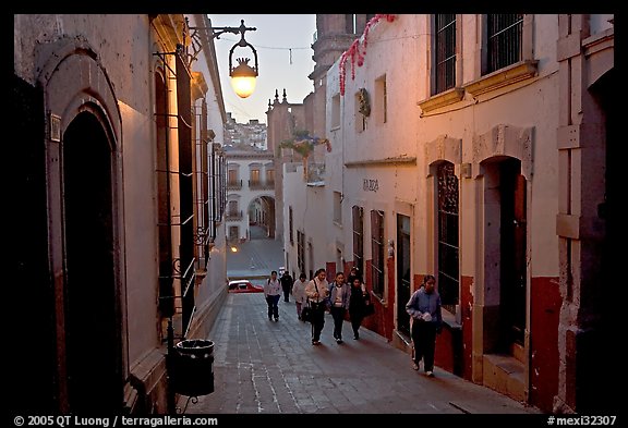 Children heading to school up a narrow cajaon, dawn. Zacatecas, Mexico