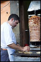 Man preparing tacos with meat. Guanajuato, Mexico (color)