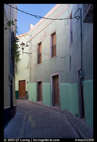 Narrow street with green houses. Guanajuato, Mexico