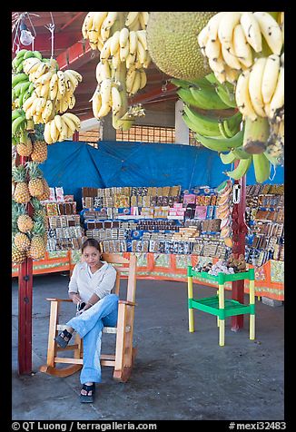 Woman sitting in a fruit stand. Mexico (color)