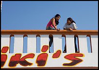 Young women sitting on a roof. Mexico