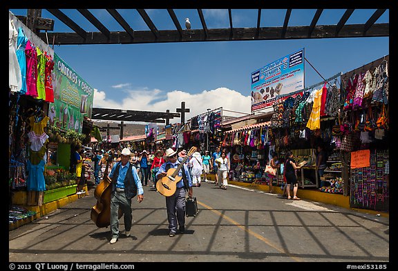Musicians walking in flee market, La Bufadora. Baja California, Mexico (color)