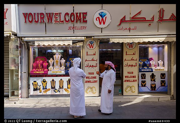 Men in front of jewellery, Gold Souk, Deira. United Arab Emirates
