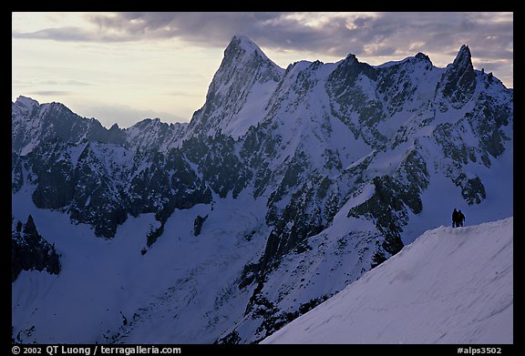 Alpinists go down Aiguille du Midi on a sharp ridge. Alps, France