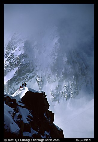 Alpinists on a buttress of Aiguille du Midi climbing the Cosmiques ridge. Alps, France