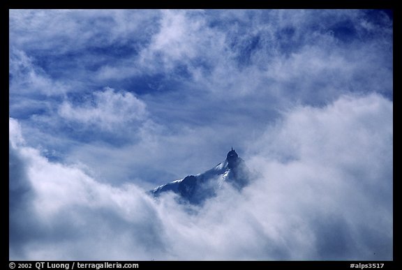 Aiguille du Midi summit emerges from the clouds. Alps, France