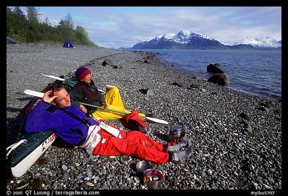 Kayakers relaxing on a beach between Rendu Inlet and Russel Island. Glacier Bay National Park, Alaska