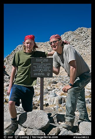Father and son standing next to Bishop Pass sign. Kings Canyon National Park, California (color)