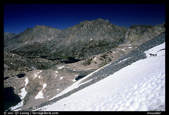 Snow field below Glen Pass with hikers in the distance, Kings Canyon National Park. California