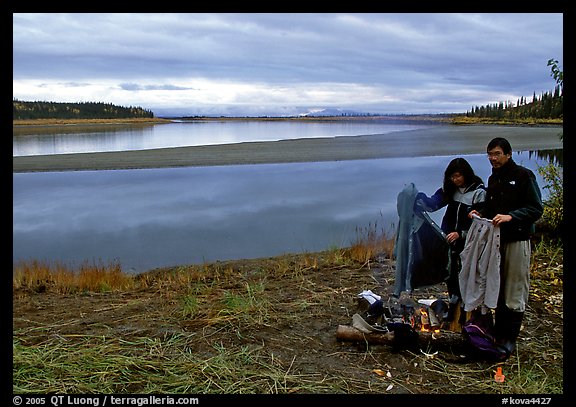 Canoeist drying out clothing over a campfire. Kobuk Valley National Park, Alaska (color)