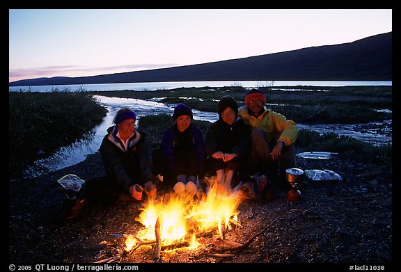 Warming toes on campfire next to Turquoise Lake. Lake Clark National Park, Alaska (color)