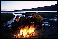 Warming toes on campfire next to Turquoise Lake. Lake Clark National Park, Alaska