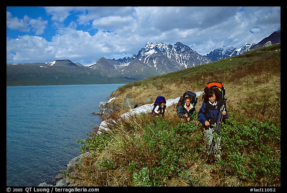 Backpackers travelling cross-country on the shore of Turquoise Lake. Lake Clark National Park, Alaska (color)