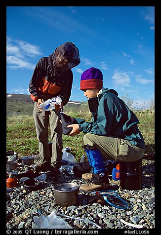 Backpackers transfering water. Lake Clark National Park, Alaska (color)