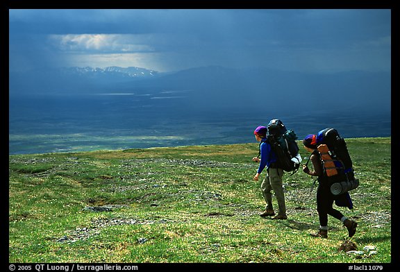 Two backpackers arrive at a ridge as a storm clears. Lake Clark National Park, Alaska (color)