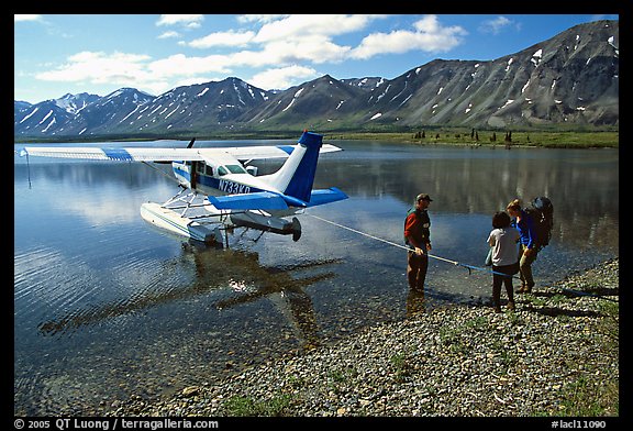 Backpackers being picked up by floatplane at Twin Lakes. Lake Clark National Park, Alaska (color)