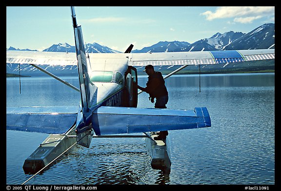 Pilot standing on floats of Floatplane, Twin Lakes. Lake Clark National Park, Alaska