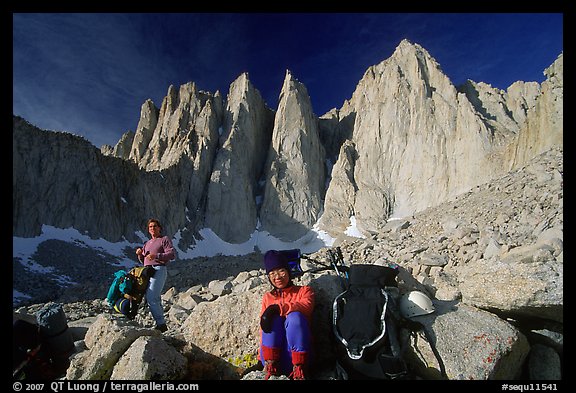 Man and woman pausing with backpacks below the East face of Mt Whitney. California