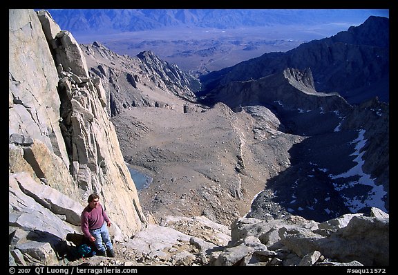 Man pausing on steep terrain in the East face of Mt Whitney. California
