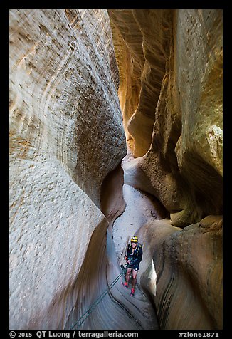 Canyonneer using rope to descend into narrows, Mystery Canyon. Zion National Park (color)