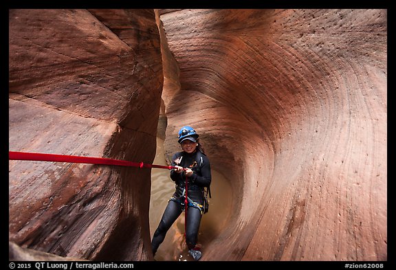 Canyoneer descending Keyhole Canyon using a sling. Zion National Park, Utah (color)