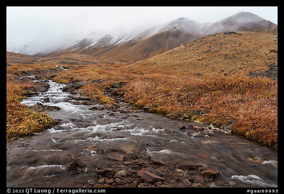 Creek flowing below peaks with fresh snow. Gates of the Arctic National Park (color)