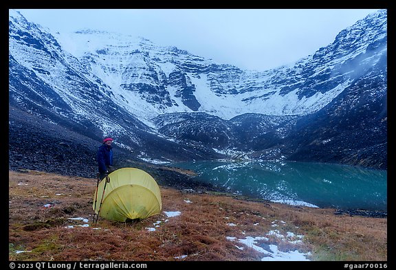 Camper standing by tent near  Lake and Three River Mountain. Gates of the Arctic National Park (color)