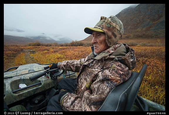 Nunamiut subsistence hunter driving all-terrain vehicle. Gates of the Arctic National Park (color)