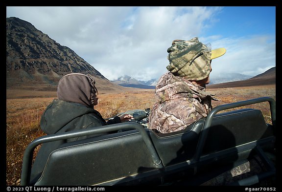 Nunamiut family on all-terrain vehicle from the back. Gates of the Arctic National Park (color)
