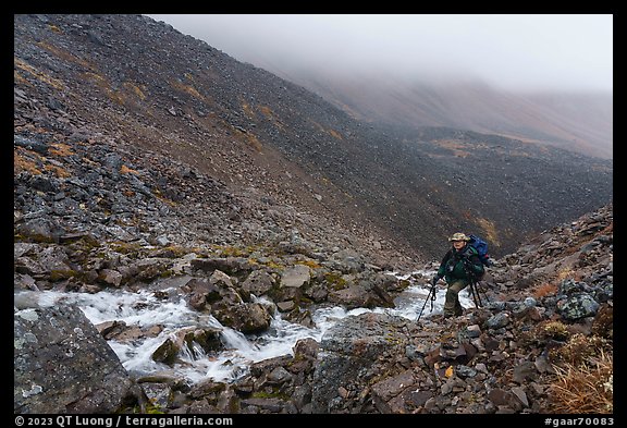 Hiker in rocky gorge, Three River Mountain. Gates of the Arctic National Park (color)